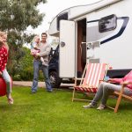 Family Enjoying Camping Holiday In Camper Van